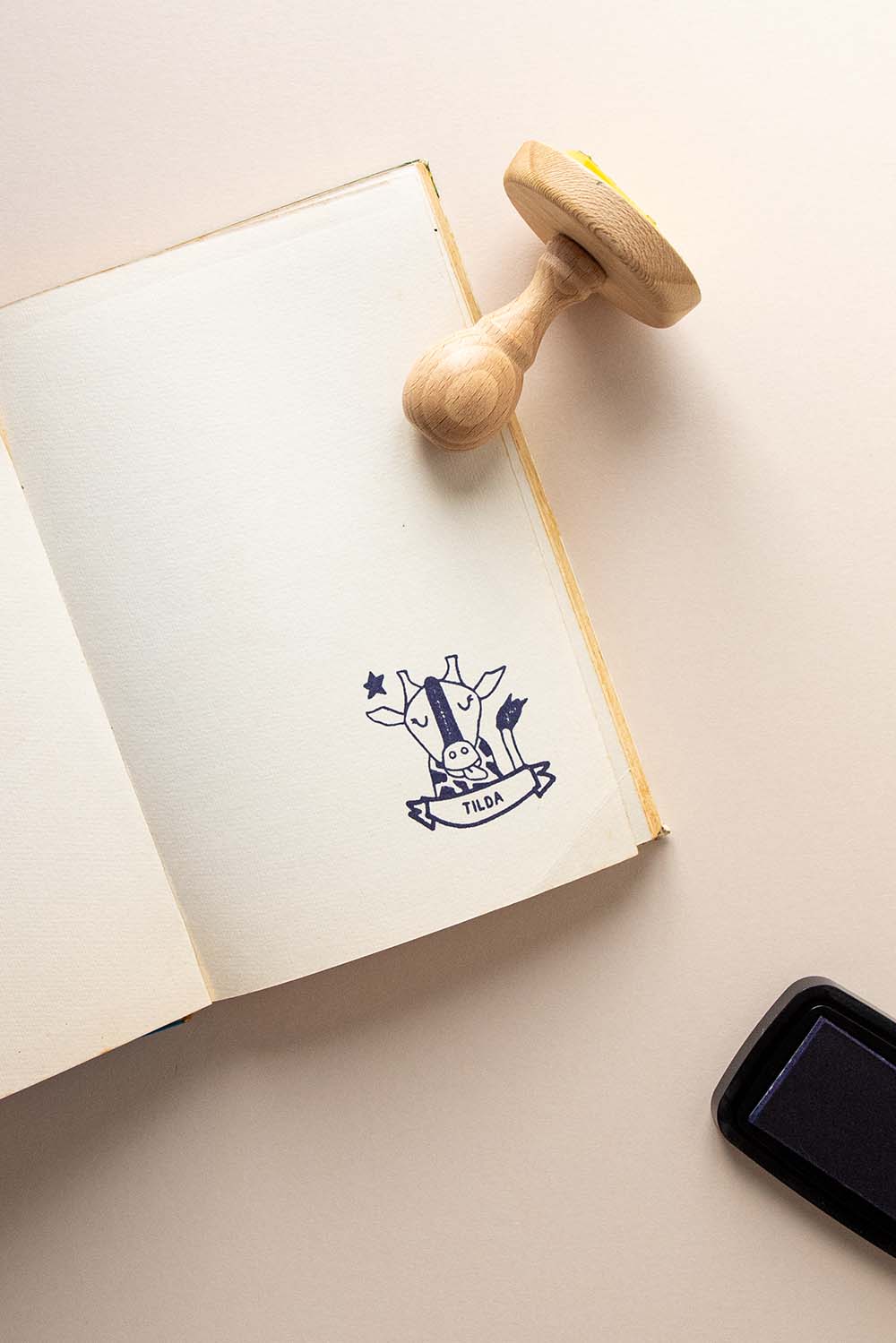 Portadilla de libro estampada con una jirafa y sello