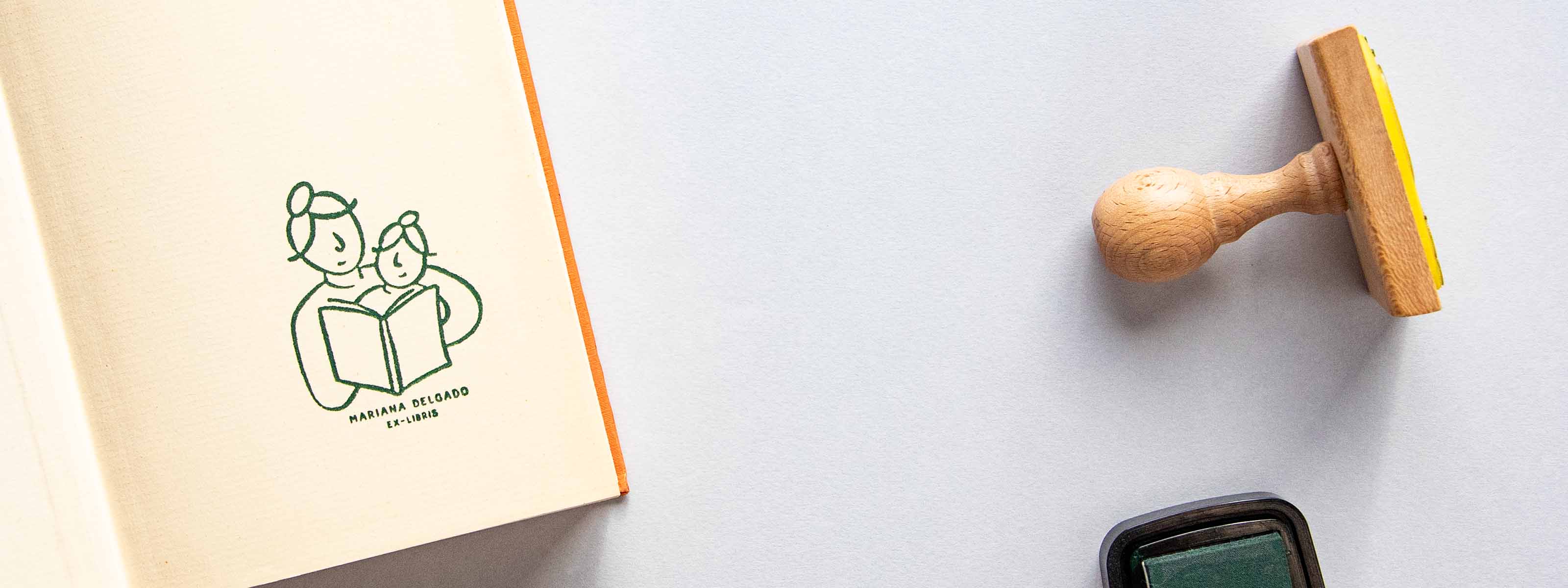 Personalized bookplate stamped on an open book's front page with a mother and daughter sharing a reading moment