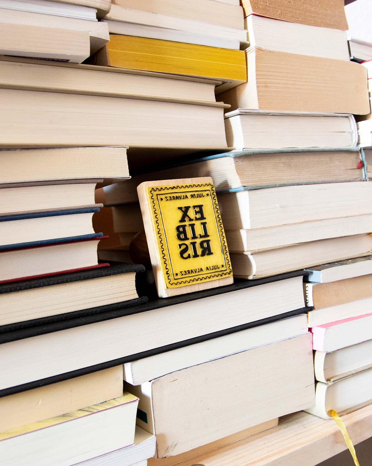 Bookplate stamp in the middle of a stack of books